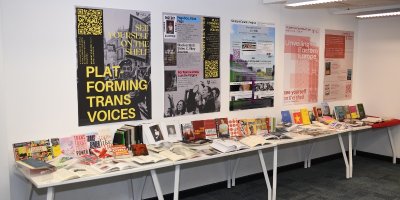 A display featuring posters and books in the library